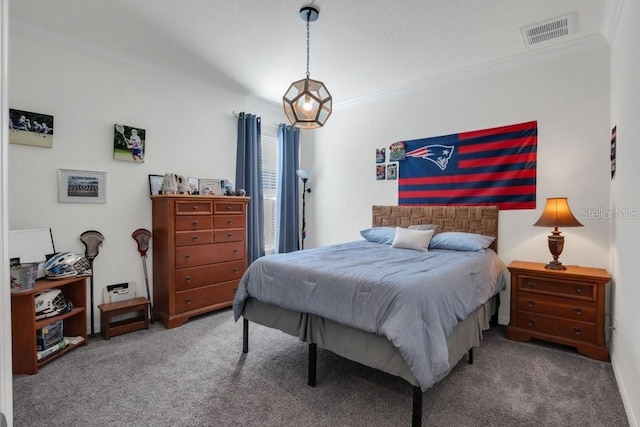 carpeted bedroom with visible vents and ornamental molding