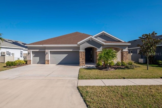 view of front of property featuring central AC unit, a garage, and a front yard