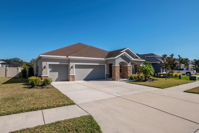 view of front facade with driveway, an attached garage, stucco siding, a front lawn, and stone siding