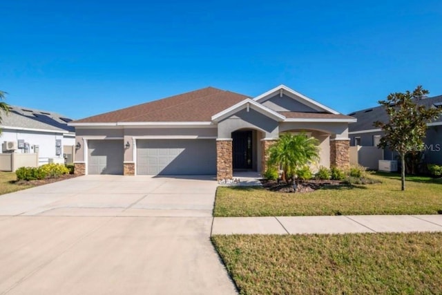 view of front of property featuring a garage, stone siding, a front yard, and stucco siding