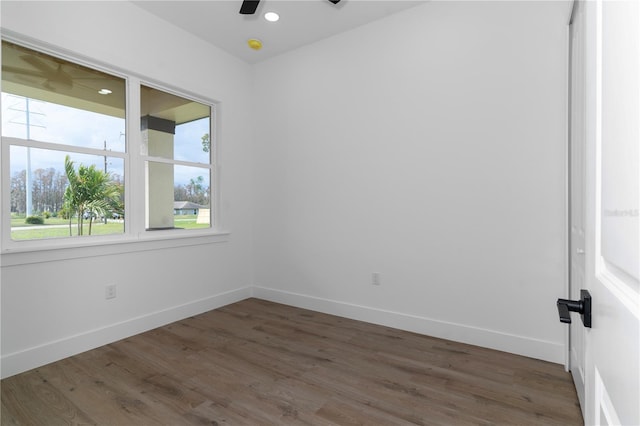 spare room featuring ceiling fan and dark wood-type flooring