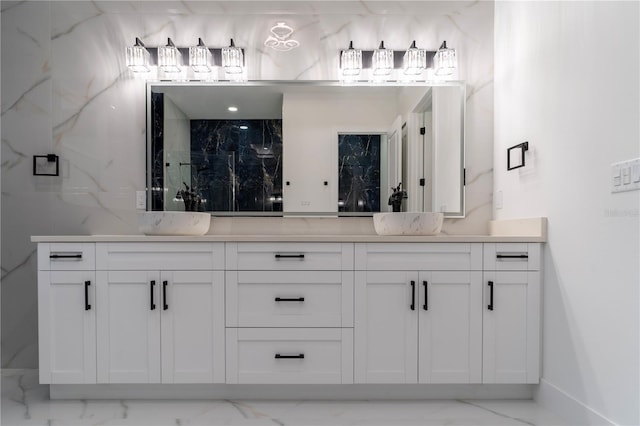 full bath with marble finish floor, a sink, and double vanity