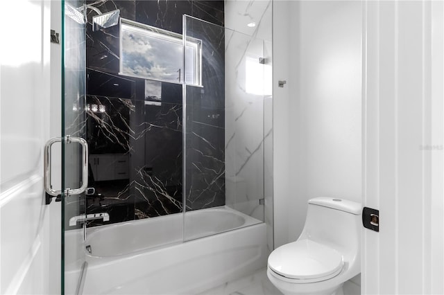 bathroom featuring toilet and enclosed tub / shower combo