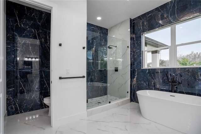 bathroom featuring separate shower and tub, toilet, and tile walls