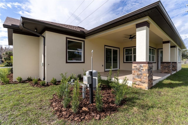 exterior space featuring ceiling fan, a patio area, and a front yard