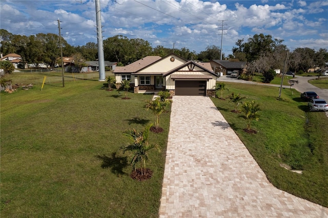 view of front of home with a front lawn and a garage