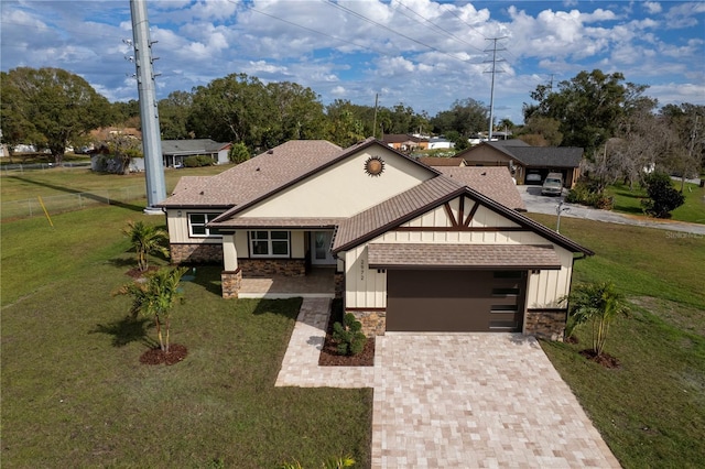 view of front of house featuring a garage and a front lawn