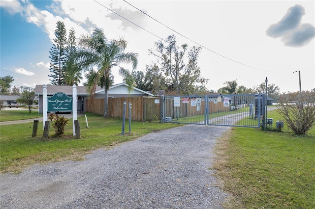 view of street featuring driveway, a gate, and a gated entry