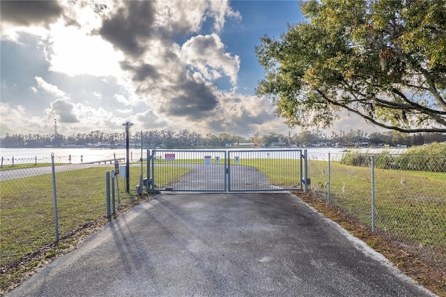 view of gate featuring a yard and fence