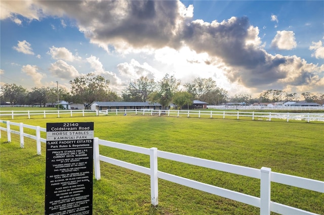 view of yard with a rural view and fence