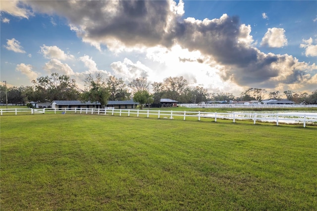 view of yard featuring fence and a rural view