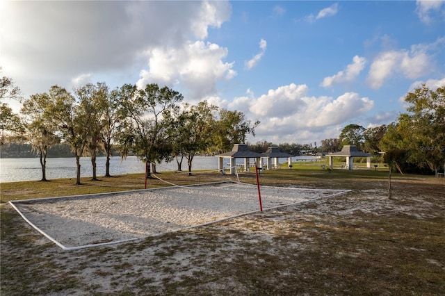 view of community featuring a water view, volleyball court, and a gazebo