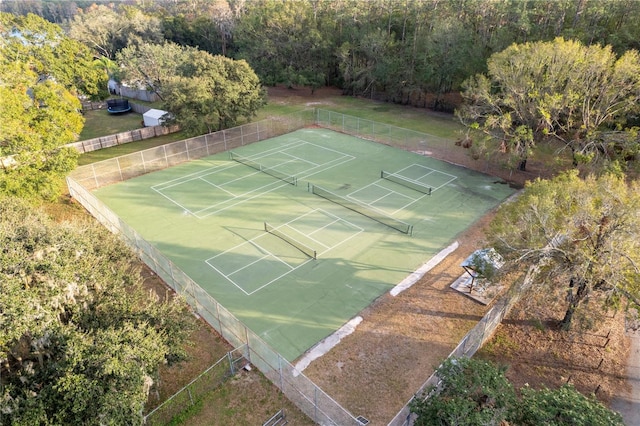 exterior space featuring a tennis court and fence