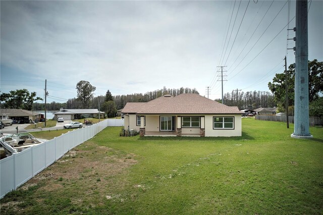 2972 Lake Saxon Dr, Land O Lakes, FL 34639 - back of house featuring stucco siding and a shingled roof