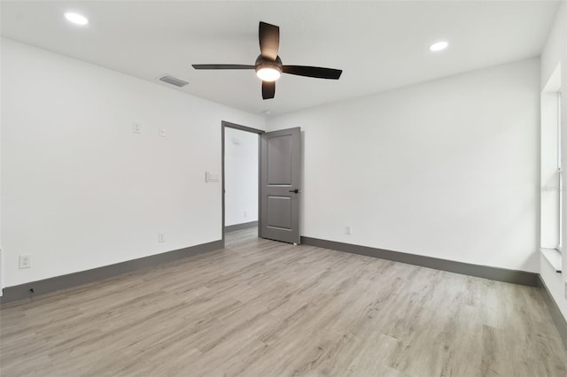 empty room featuring ceiling fan and light wood-type flooring