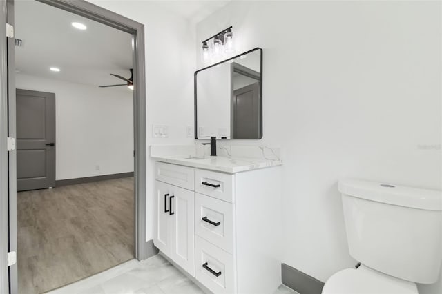 bathroom with ceiling fan, vanity, and toilet