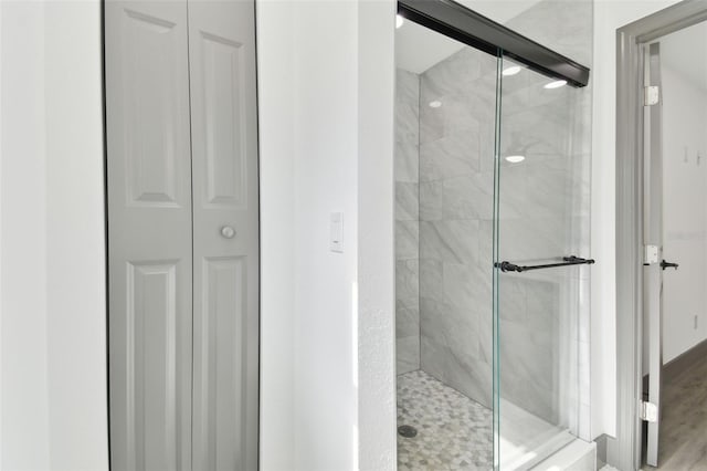 bathroom featuring a shower with shower door