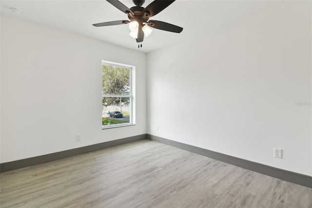 spare room with light hardwood / wood-style flooring and ceiling fan