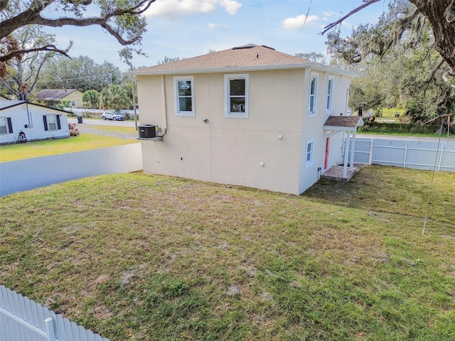 view of home's exterior with cooling unit and a lawn