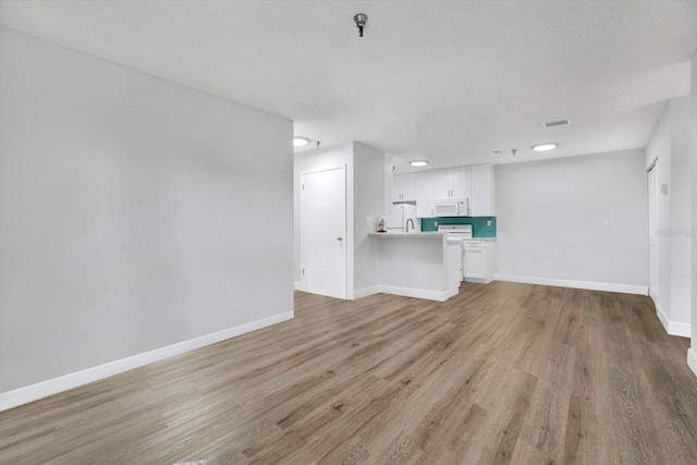 unfurnished living room featuring light wood-type flooring