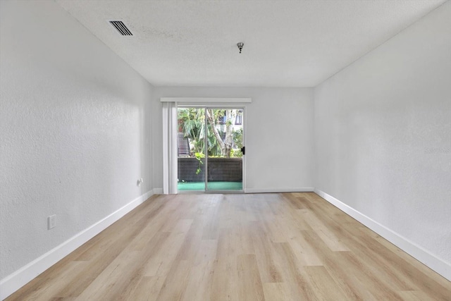 unfurnished room with light wood-type flooring