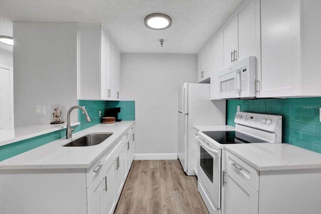 kitchen featuring white cabinets, white appliances, and sink