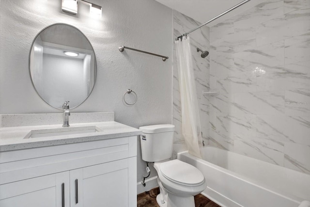 full bathroom with vanity, shower / tub combo, and toilet