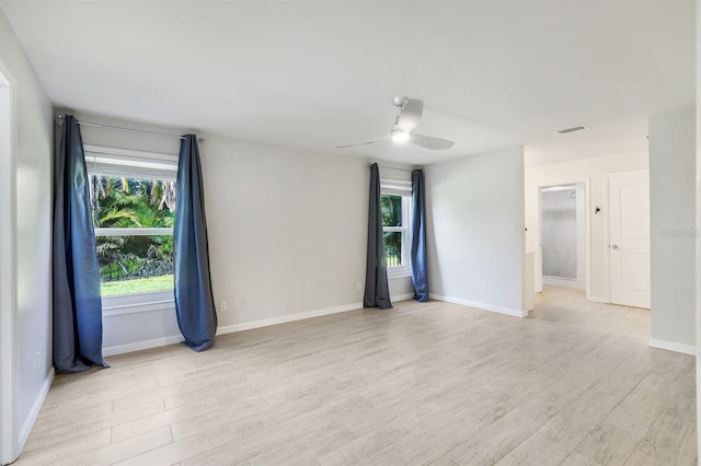 empty room with ceiling fan and light wood-type flooring