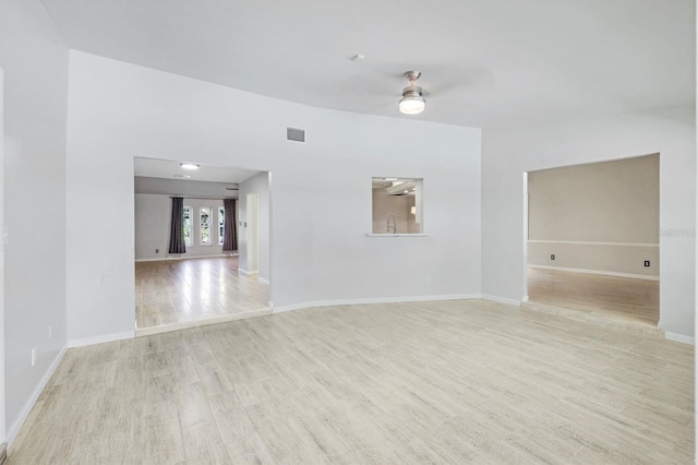 spare room featuring ceiling fan and light wood-type flooring