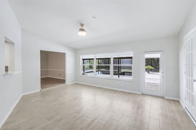 unfurnished room with lofted ceiling