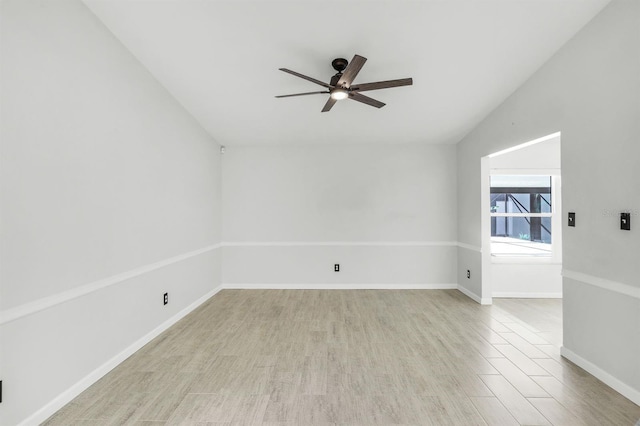 empty room with light wood-type flooring, ceiling fan, and lofted ceiling