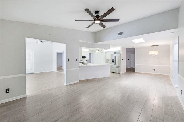 unfurnished living room with ceiling fan and light wood-type flooring