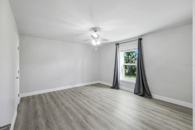 spare room featuring light hardwood / wood-style flooring and ceiling fan