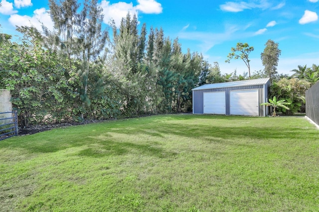 view of yard with a garage and an outdoor structure