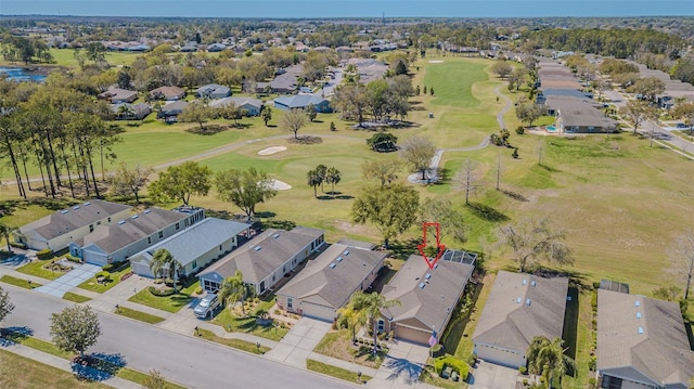 drone / aerial view with a residential view and golf course view