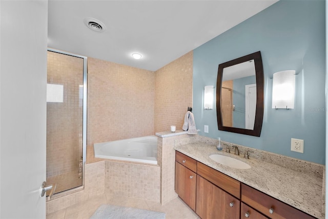 bathroom with tile patterned floors, vanity, and shower with separate bathtub