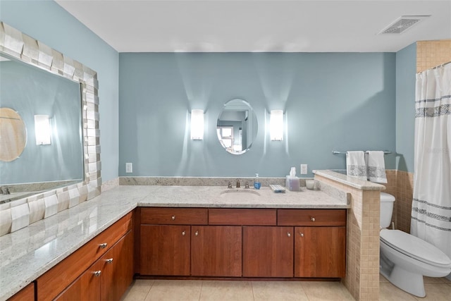 bathroom featuring tile patterned flooring, vanity, and toilet