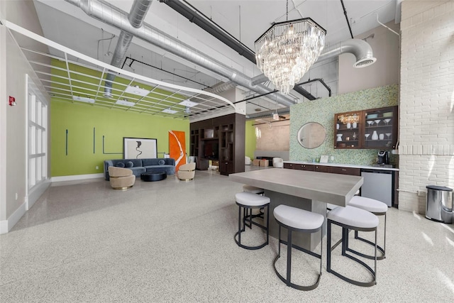 dining area featuring a high ceiling and an inviting chandelier