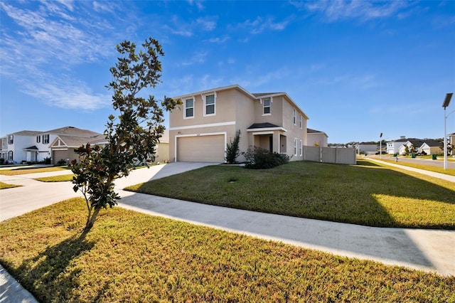 view of property featuring a garage and a front lawn