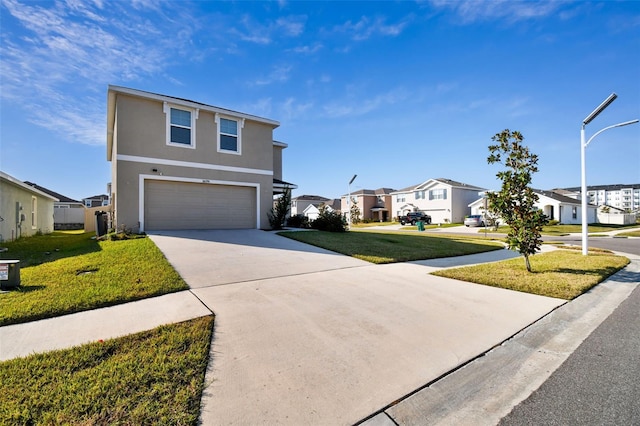 view of front of house with a garage and a front lawn