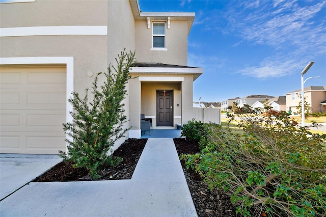 view of exterior entry with a garage