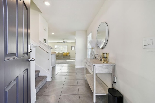 tiled foyer with ceiling fan