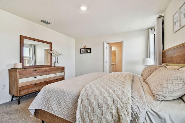 bedroom featuring carpet floors and a textured ceiling