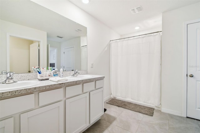 bathroom featuring vanity, tile patterned floors, and walk in shower