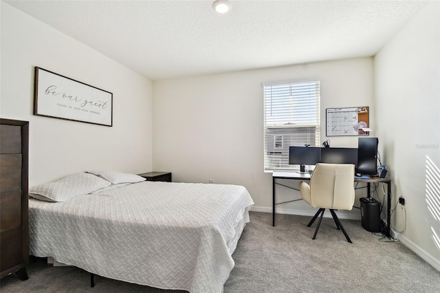 bedroom with carpet floors and a textured ceiling