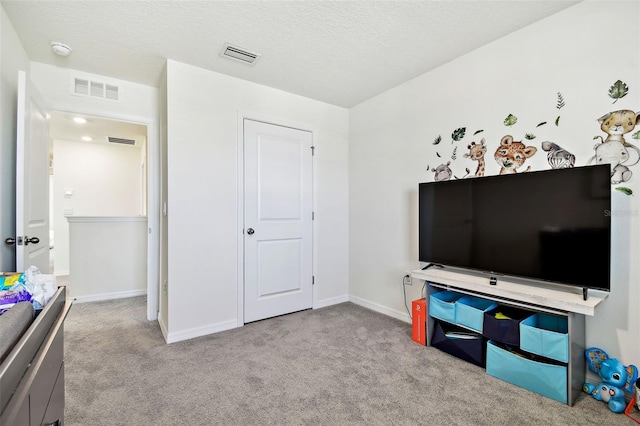 interior space with light carpet and a textured ceiling