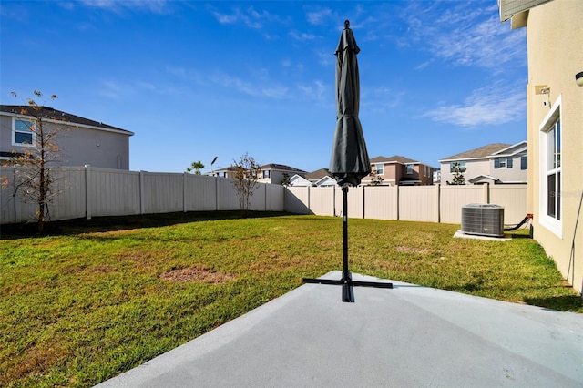 view of yard with central AC and a patio area