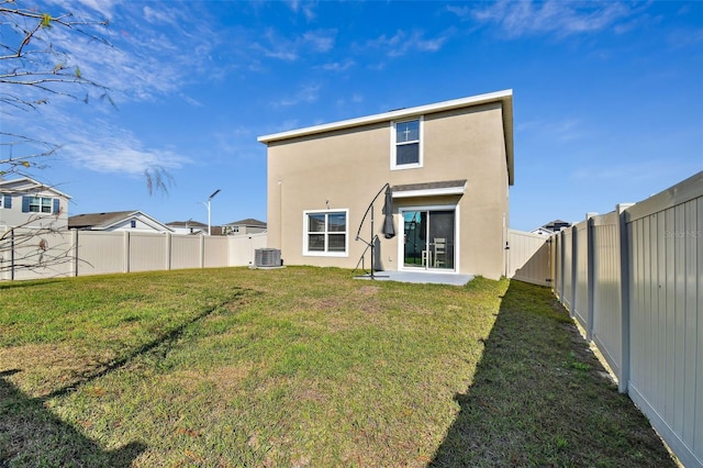 back of property featuring central air condition unit and a lawn