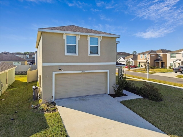 view of front of home featuring a garage and a front lawn