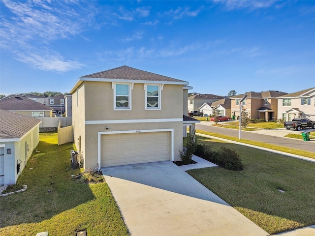 view of front of property with a garage and a front lawn